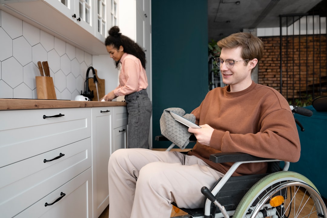 a-man-in-a-wheel-chair-in-a-kitchen-75xbity2szk